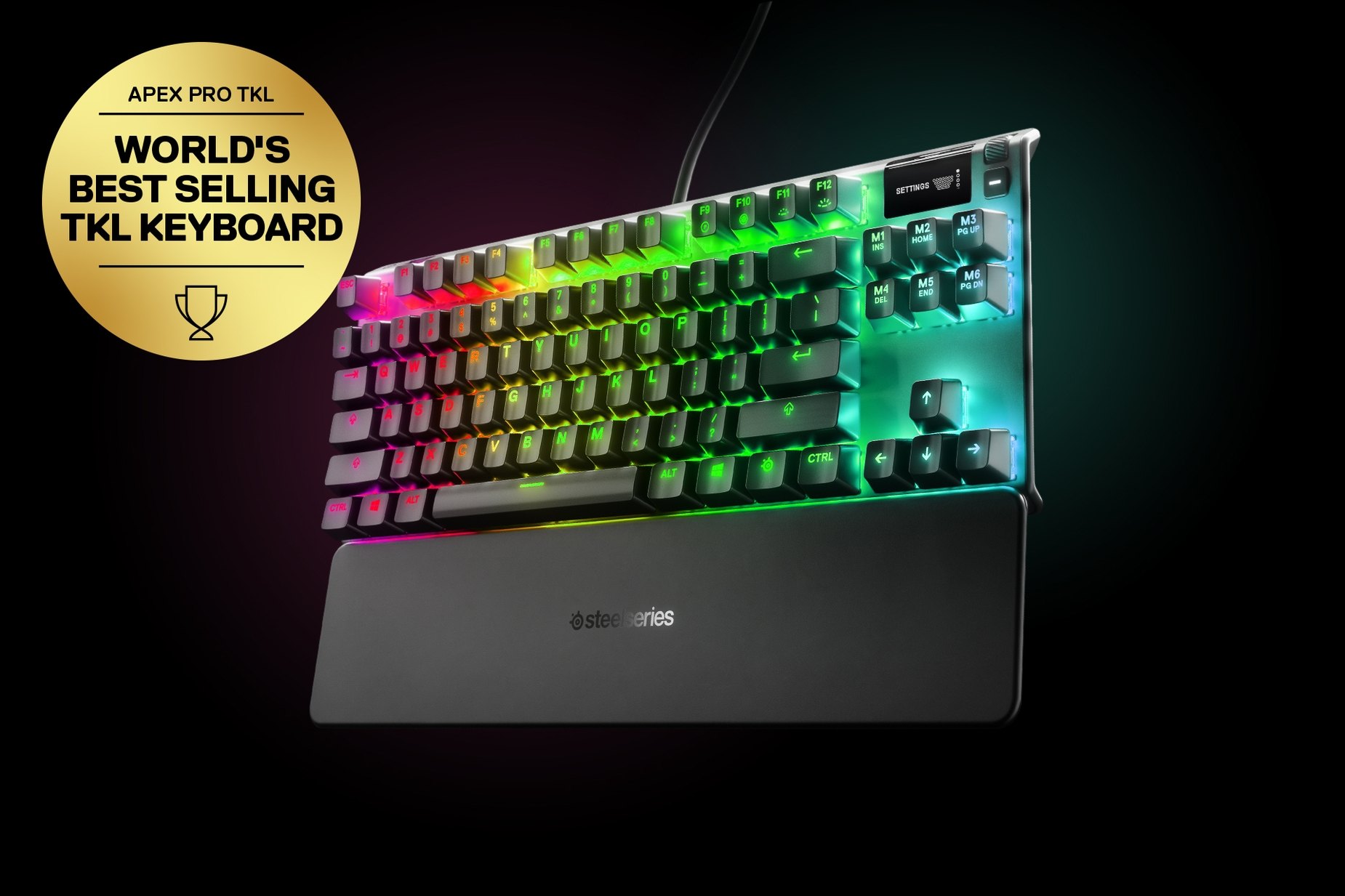 
 German - Apex Pro TKL gaming keyboard with the illumination lit up on dark background, also shows the OLED screen and controls used to change settings, switch actuation, and adjust audio. Keyboard has gold award floating next to it with text "World's best selling TKL Keyboard".
 